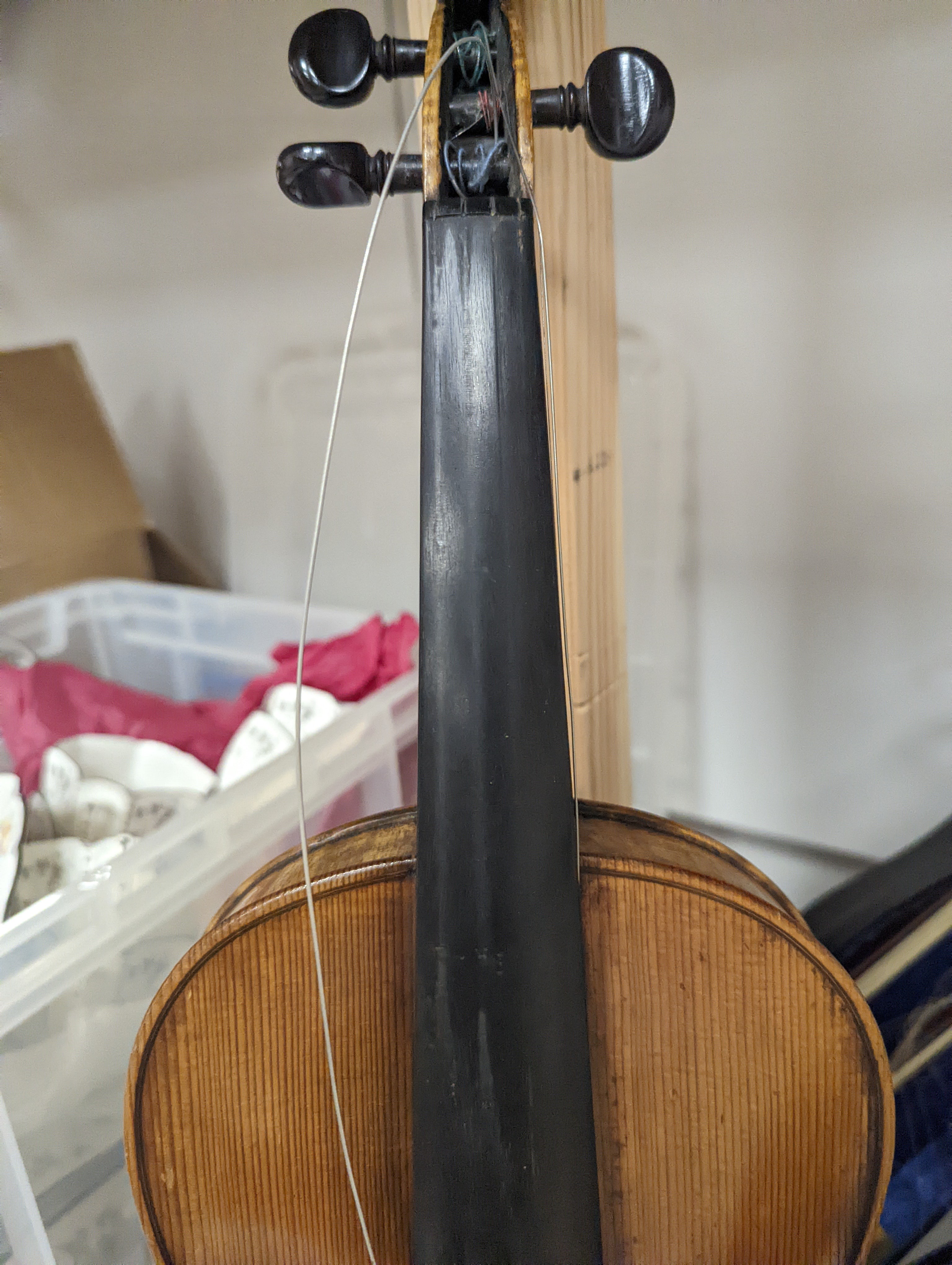 An early 20th century French or English violin with two bows, each stamped